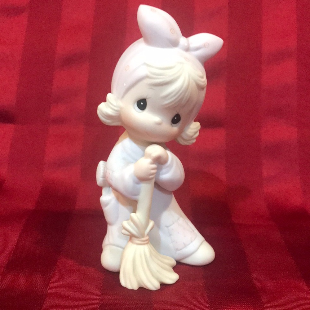 Adorable Figurine with Bow and Broom